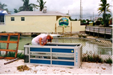 In the Bahamas Marcia overcomes a small problem with local phone company equipment to contact her editor.