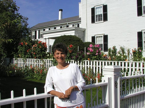 Photo of Marcia Talley with white fence and roses in the background