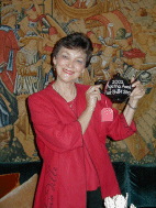 Marcia holding the Agatha Award